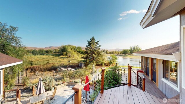 wooden deck with a water view