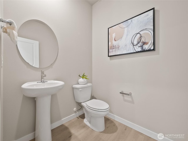 16226 SE 133rd Pl Unit 104, Renton, WA 98059 - bathroom with toilet, wood finished floors, and baseboards