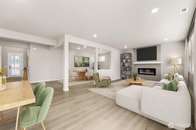 16226 SE 133rd Pl Unit 104, Renton, WA 98059 - living room featuring recessed lighting, light wood-style flooring, healthy amount of natural light, a glass covered fireplace, and baseboards