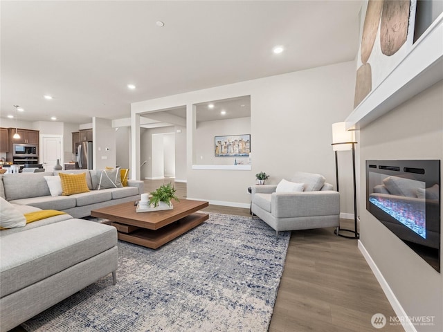 16226 SE 133rd Pl Unit 104, Renton, WA 98059 - living area with a glass covered fireplace, wood finished floors, recessed lighting, and baseboards