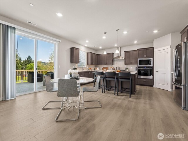 16226 SE 133rd Pl Unit 104, Renton, WA 98059 - dining area with light wood-type flooring and recessed lighting