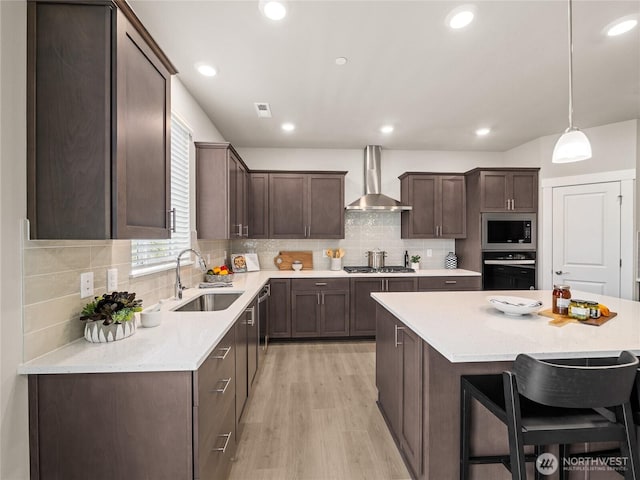 16226 SE 133rd Pl Unit 104, Renton, WA 98059 - kitchen featuring stainless steel appliances, wall chimney exhaust hood, a sink, dark brown cabinets, and decorative backsplash