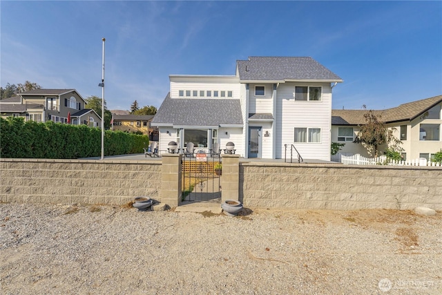 117 Water St, Chelan, WA 98816 - rear view of property featuring a residential view, fence private yard, a gate, and a shingled roof