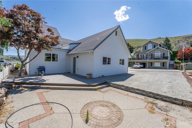 117 Water St, Chelan, WA 98816 - back of house with roof with shingles, a deck, and fence