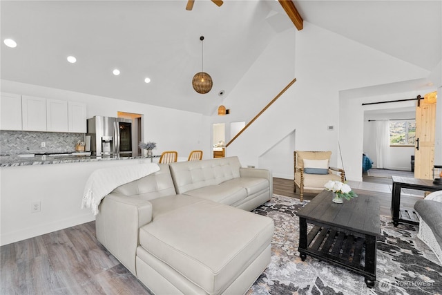 117 Water St, Chelan, WA 98816 - living area with a barn door, light wood-type flooring, beamed ceiling, recessed lighting, and high vaulted ceiling