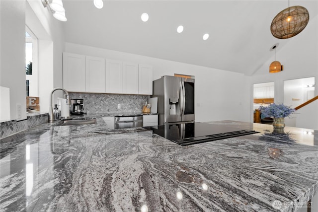 117 Water St, Chelan, WA 98816 - kitchen featuring white cabinetry, stone countertops, appliances with stainless steel finishes, a sink, and decorative light fixtures