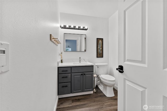 117 Water St, Chelan, WA 98816 - half bath featuring toilet, wood finished floors, vanity, and baseboards