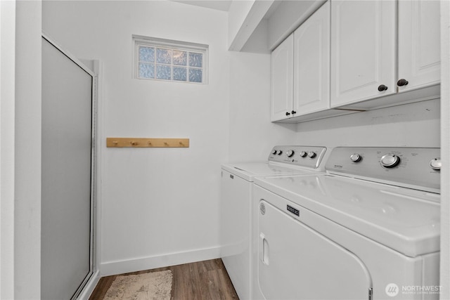 117 Water St, Chelan, WA 98816 - laundry room featuring dark wood-style flooring, baseboards, washing machine and clothes dryer, and cabinet space