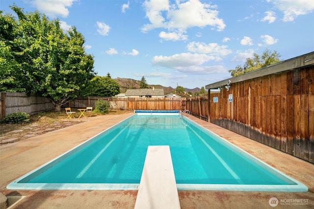 1315 Poe St, Wenatchee, WA 98801 - view of pool with a fenced backyard, a diving board, and a patio