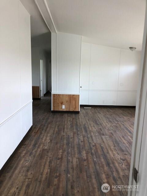 unfurnished room featuring dark wood-style flooring