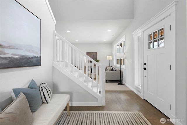 entryway with recessed lighting, baseboards, stairs, and wood finished floors