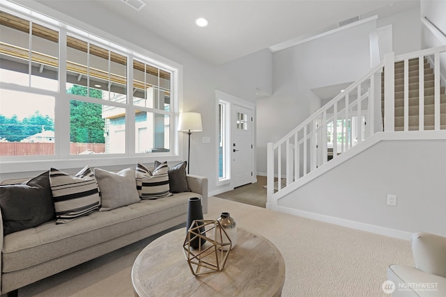 living area featuring stairway, recessed lighting, baseboards, carpet floors, and visible vents