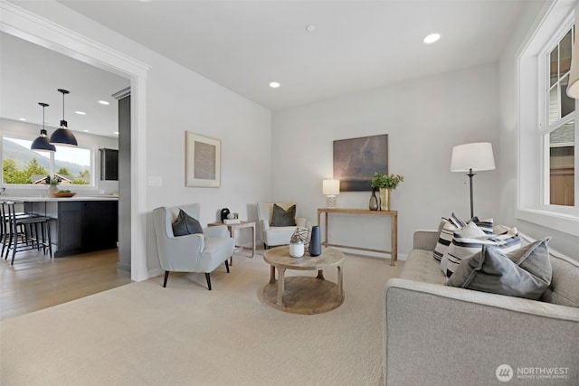 living room featuring light carpet and recessed lighting