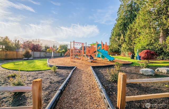 community playground featuring a lawn and fence