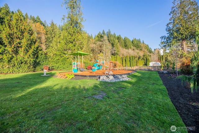 view of yard featuring fence and a playground