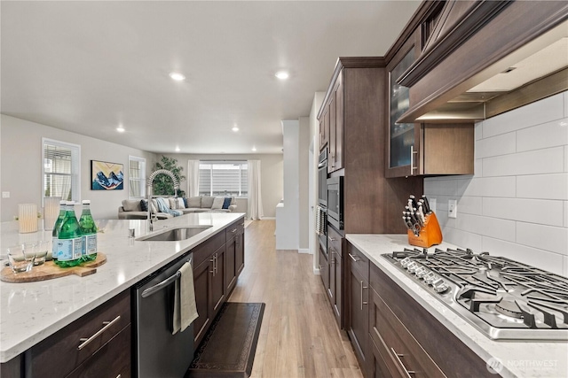 22819 SE Fir St, Black Diamond, WA 98010 - kitchen with dark brown cabinets, appliances with stainless steel finishes, a sink, open floor plan, and premium range hood