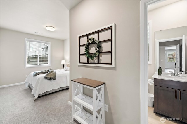 22819 SE Fir St, Black Diamond, WA 98010 - bedroom with light carpet, a sink, and baseboards