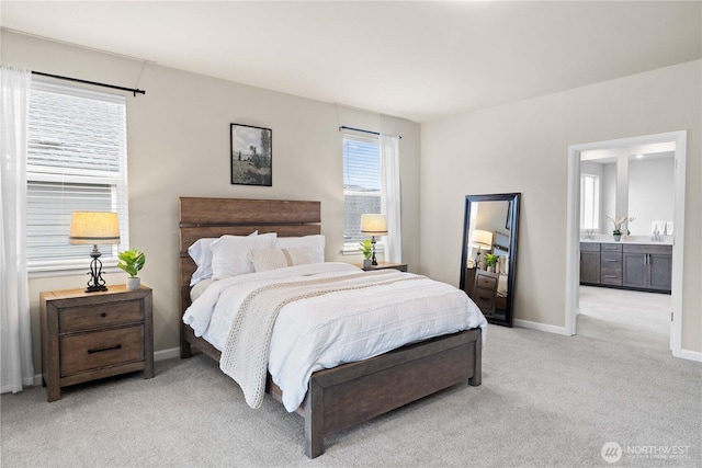 22819 SE Fir St, Black Diamond, WA 98010 - bedroom featuring baseboards, connected bathroom, and light carpet