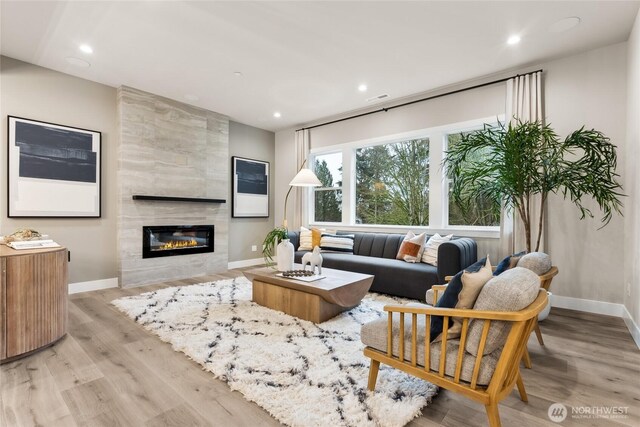 16306 SE 133rd Pl Unit 105, Renton, WA 98059 - living area with a tiled fireplace, light wood finished floors, and recessed lighting