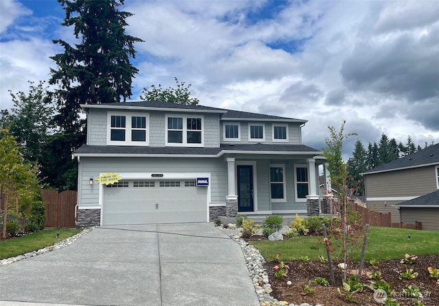 16306 SE 133rd Pl Unit 105, Renton, WA 98059 - view of front of home with concrete driveway, stone siding, a garage, and a porch