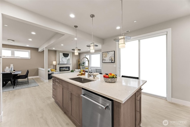 16306 SE 133rd Pl Unit 105, Renton, WA 98059 - kitchen featuring stainless steel dishwasher, light wood-type flooring, open floor plan, a glass covered fireplace, and recessed lighting