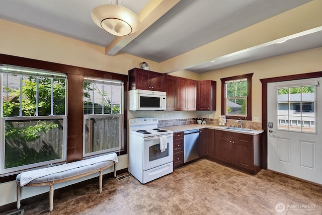 250 SE Andrews St, Issaquah, WA 98027 - kitchen featuring white appliances, light countertops, beam ceiling, and a sink