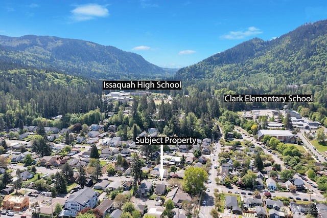 250 SE Andrews St, Issaquah, WA 98027 - aerial view of property's location with a mountain backdrop, a heavily wooded area, and nearby suburban area