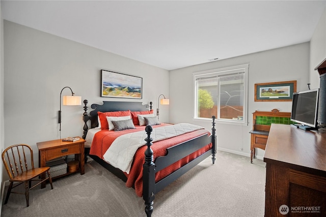 bedroom featuring visible vents, light colored carpet, and baseboards