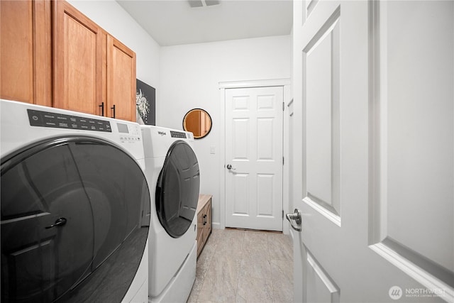laundry area featuring cabinet space and washing machine and clothes dryer