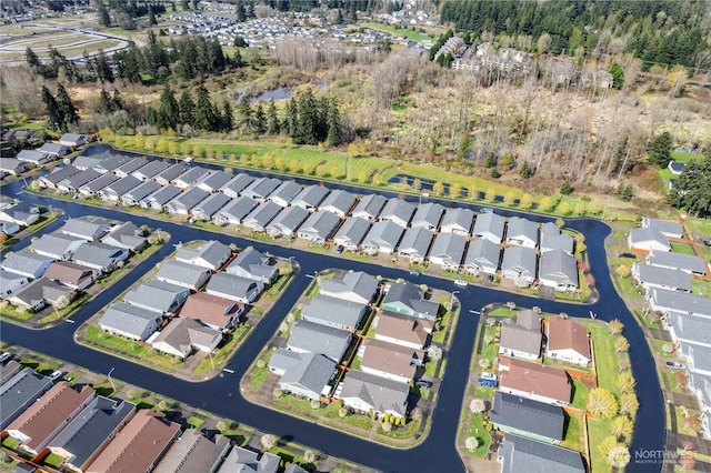 drone / aerial view with a residential view and a water view