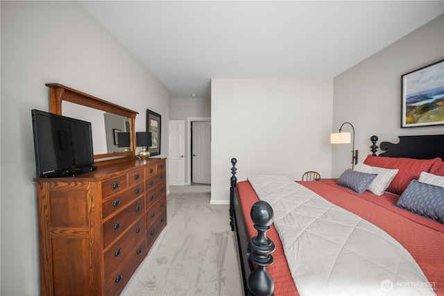 bedroom with light colored carpet and baseboards