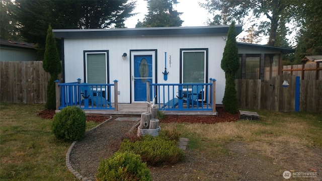 view of front of property with a front yard and fence