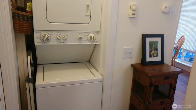 laundry room with stacked washer and clothes dryer and laundry area