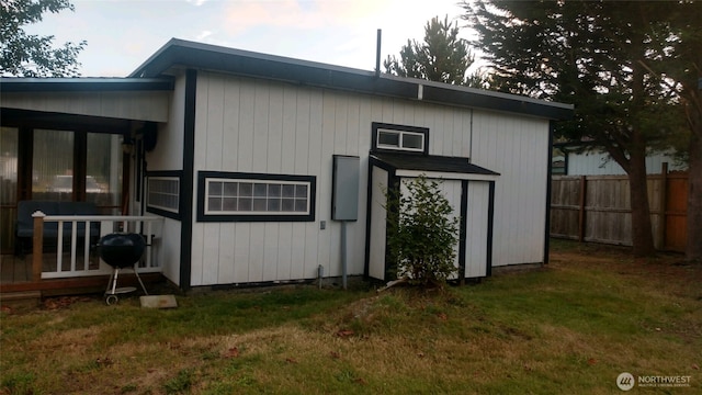 view of outbuilding featuring fence