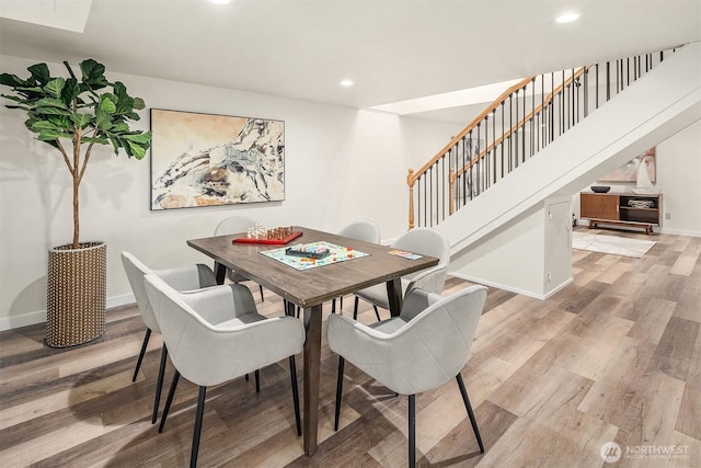 dining room with recessed lighting, stairway, light wood-style floors, and baseboards