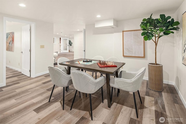 dining space with light wood-type flooring, baseboards, and recessed lighting