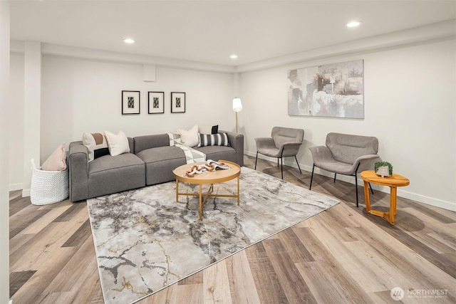 living area featuring recessed lighting, baseboards, and wood finished floors