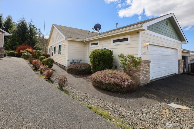 204 Brant Ln, Hoquiam, WA 98550 - view of home's exterior with a garage and roof with shingles