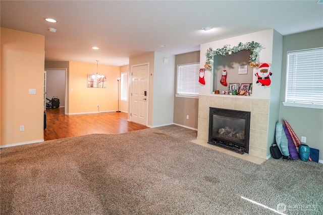 204 Brant Ln, Hoquiam, WA 98550 - carpeted living area featuring a notable chandelier, baseboards, a fireplace, and recessed lighting