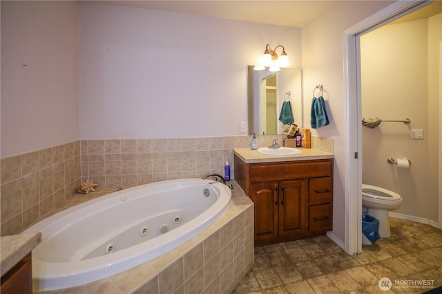 204 Brant Ln, Hoquiam, WA 98550 - full bathroom featuring toilet, a tub with jets, and vanity