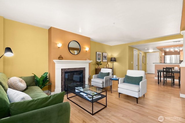 living area with light wood-style floors and a fireplace
