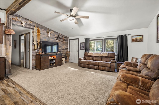 14205 205th Street Ct E, Graham, WA 98338 - carpeted living area with an accent wall, lofted ceiling, a ceiling fan, and wood finished floors