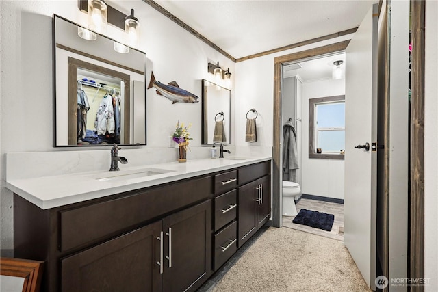 14205 205th Street Ct E, Graham, WA 98338 - full bath with double vanity, crown molding, toilet, and a sink