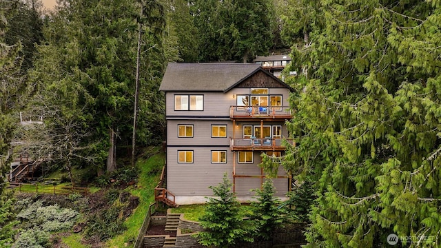 rear view of property with a balcony