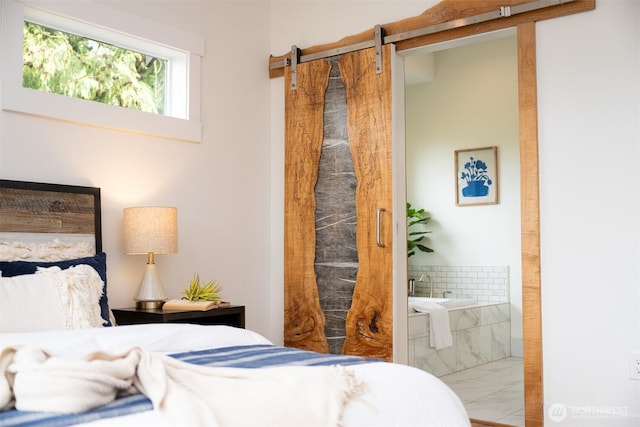 bedroom with marble finish floor and connected bathroom