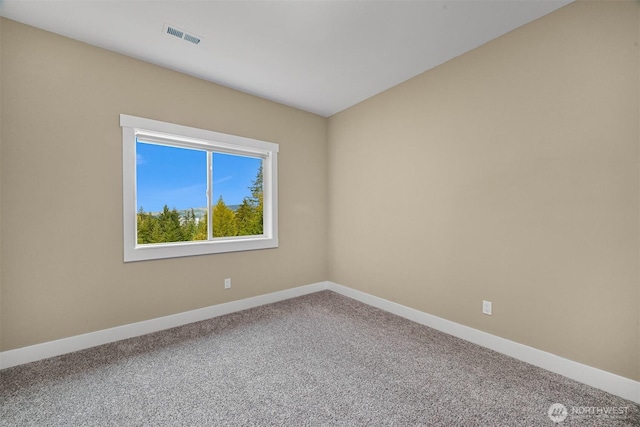 empty room with visible vents, baseboards, and carpet flooring