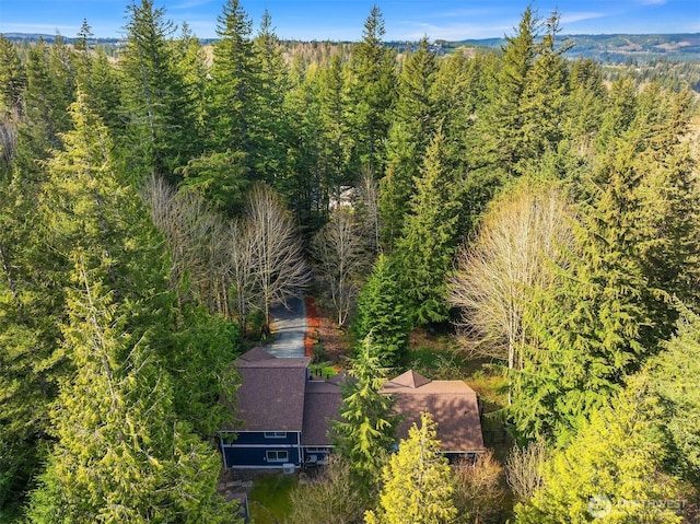 birds eye view of property with a wooded view