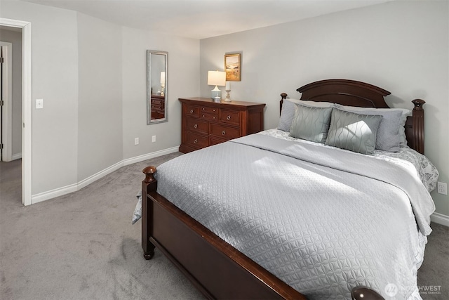 bedroom featuring baseboards and carpet