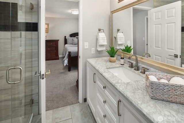 ensuite bathroom with a stall shower, vanity, ensuite bath, and tile patterned flooring