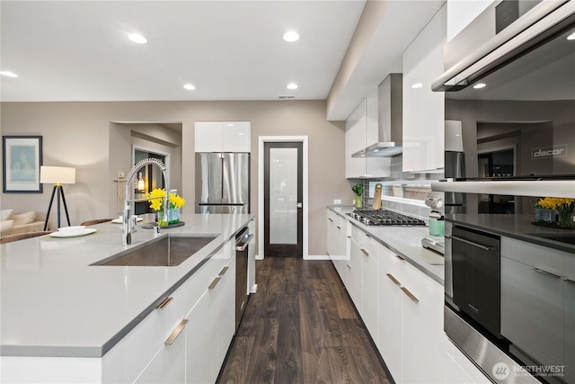 24014 Lily Pl SE, Black Diamond, WA 98010 - kitchen featuring modern cabinets, wall chimney exhaust hood, a sink, stainless steel appliances, and white cabinetry